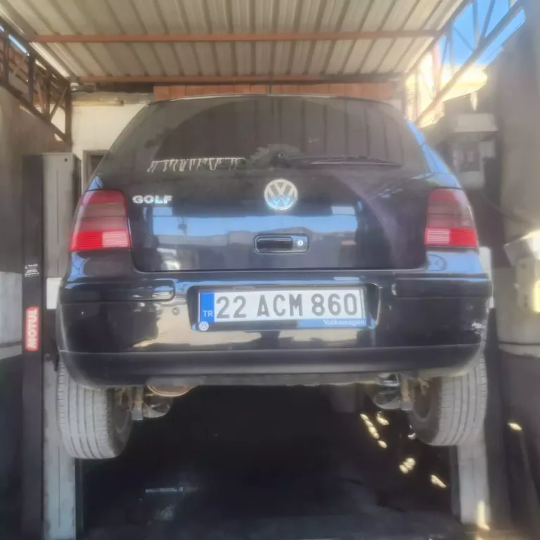 Vehicle raised for underbody inspection.